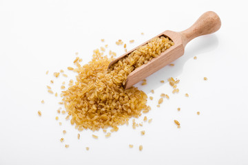 raw bulgur on a white acrylic background