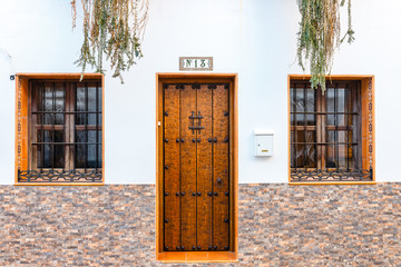 single wooden door with number thirteen on a wall