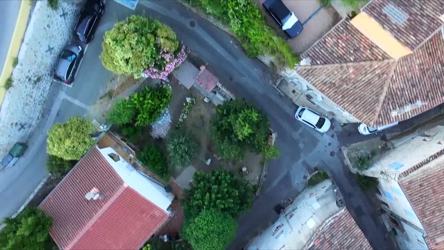Drone top shot over small french village with narrow roads and old buildings.