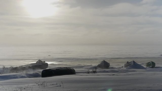 Grounded freighter canoes, windy winter snow, northern Quebec on James Bay
