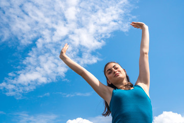 beautiful sports girl on a blue sky background after a workout