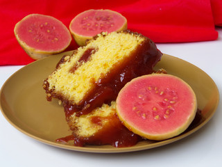 Typical Brazilian sweet dessert corn cake with guava paste. And guavas fruits  composing the scene.