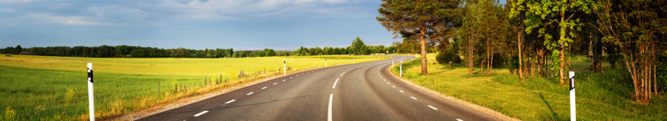 asphalt road view in countryside at beautiful sunset