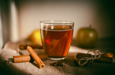 Hot apple cider beverage. Hot drink (apple tea, punch) with cinnamon stick and star anise on tote...