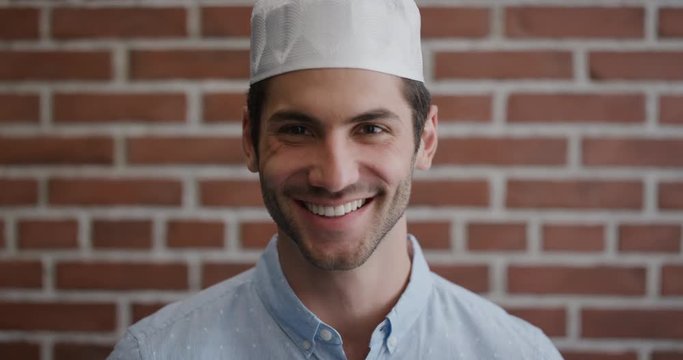 portrait attractive young muslim man smiling enjoying successful lifestyle happy independent male wearing kufi hat slow motion