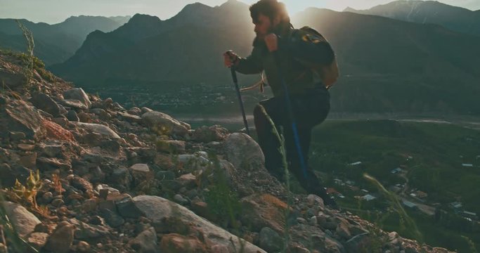 Young mountaineer hiking up a mountain. Adventurer climbing up. Adventures, zen concept 4k