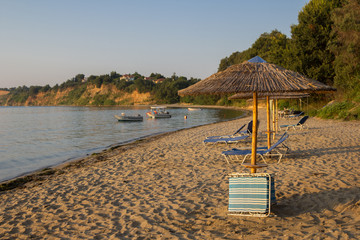Sea and umbrellas on the beach in Greece