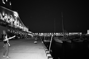Mom and daughter do selfie on the background of the station in Sochi