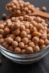 uncooked chickpeas on a dark stone background