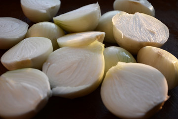Fototapeta na wymiar white onion cut in half on a wooden plate
