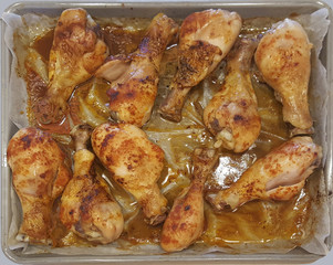 Chicken thighs baked in the oven on a pallet in the proper sauce and sprinkled with spices