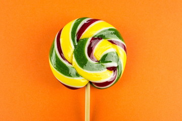 Sweet lollipop candy on a color background