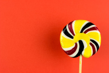 Sweet lollipop candy on a color background