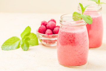 Raspberry smoothie close up photography with fresh summer blended cocktail and ripe berries.