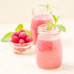 Raspberry smoothie close up photography with fresh summer blended cocktail and ripe berries.