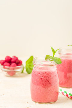 Raspberry smoothie close up photography - fresh summer blended cocktail with ripe berries.