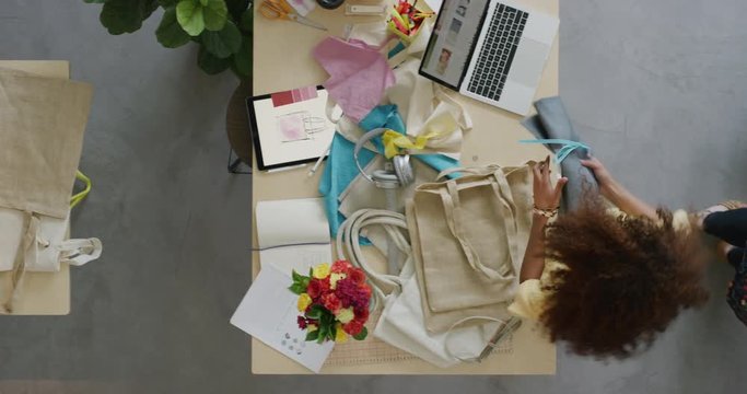 young fashion designers women packaging stylish handbags ready for courier shipment creative female entrepreneurs in small startup business overhead