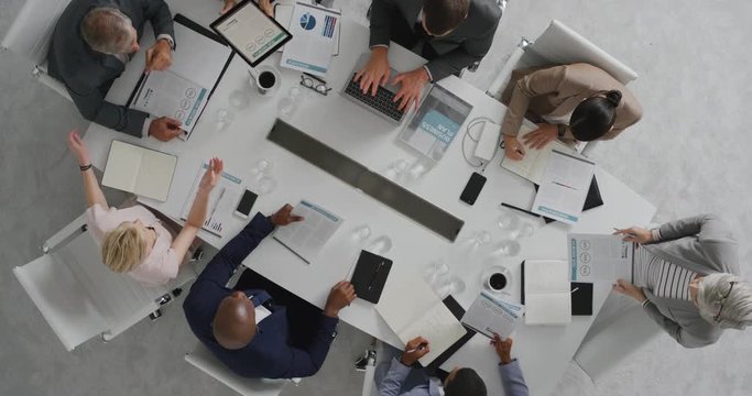 professional business people meeting in boardroom multi ethnic corporate leaders collaborating sharing ideas planning strategy using tablet pc overhead