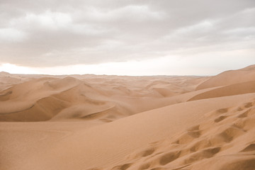 Fototapeta na wymiar Footprints in the sand of the desert outside Huacachina in Ica, Peru