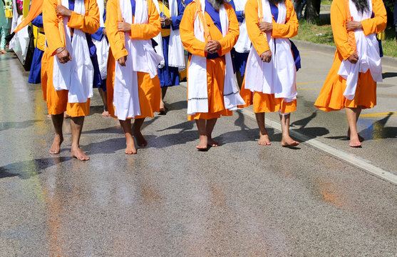Sikh men dressed in traditional orange, white and blue clothes w