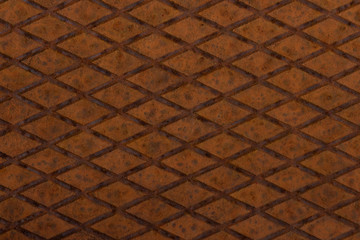 Old, orange, metal plate with diamond shaped no slip grid on it