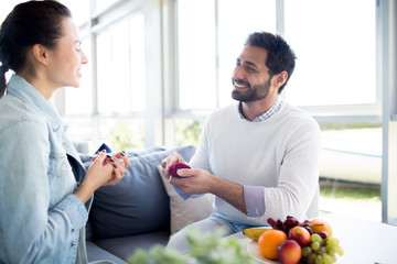 Amorous young man making proposal to his sweetheart during romantic date in cafe