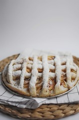 Apple pie with white towel on wooden tray. Dessert. Homemade cake with apples.