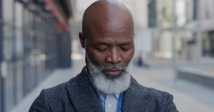 portrait successful mature african american businessman in city enjoying professional urban lifestyle senior black man commuter slow motion