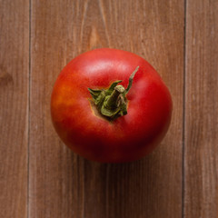 Beautiful red tomatoes on wooden background, top view