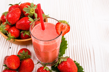 fresh strawberrysmoothie or milkshake on a wooden rustic background