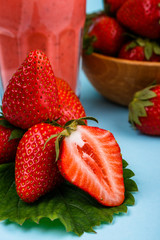 fresh strawberrysmoothie or milkshake on a delicately blue background