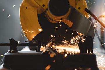Close-up view of metalworking on angular grinding machine in workshop. Sparks fly apart. Work in...