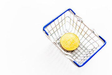 Gold coins in shopping online cart isolated on white background