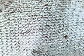 Sequins close-up macro. Abstract background with gold sequins color on the fabric.