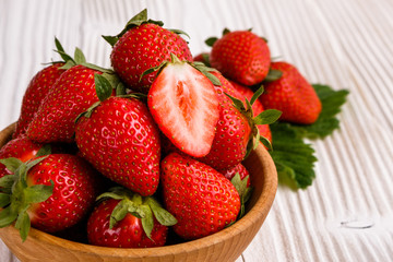 Juicy fresh strawberry on a rustic wooden background