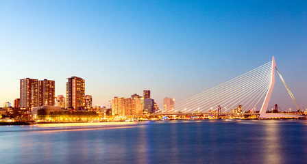 Rotterdam panorama. Erasmus bridge over the river Meuse with skyscrapers in Rotterdam, South Holland, Netherlands during twilight sunset. - obrazy, fototapety, plakaty