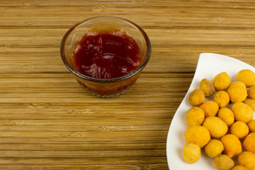 Snack on a plate. Wooden table. Salty food for beer