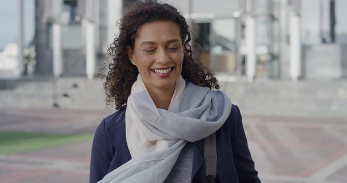 portrait successful mature business woman laughing enjoying professional urban lifestyle in city wind blowing hair
