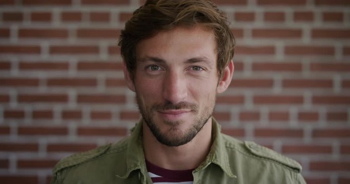 portrait attractive young caucasian man looking up smiling confident male with beard real people series