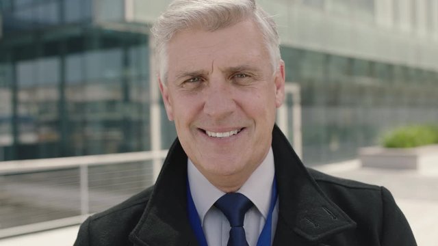 close up portrait of successful mature ceo businessman smiling happy enjoying corporate lifestyle in urban city background