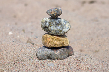 Fototapeta na wymiar the four stones on the sand