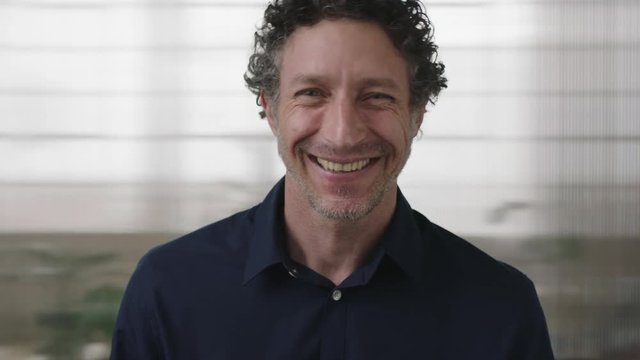 close up portrait of handsome mature entrepreneur man laughing happy enjoying successful business career opportunity