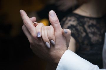 Close-up of the hands of a man and a woman during a slow dance. Elements of a dancing couple.