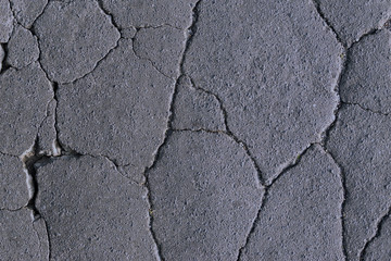 cracks on the asphalt, road destruction, beautiful abstract background of cracks