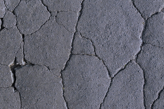 cracks on the asphalt, road destruction, beautiful abstract background of cracks