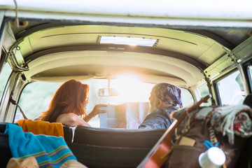 Senior hipster couple going on vacation in a camper van