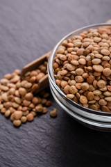 raw lentils on a dark stone background