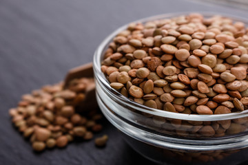 raw lentils on a dark stone background