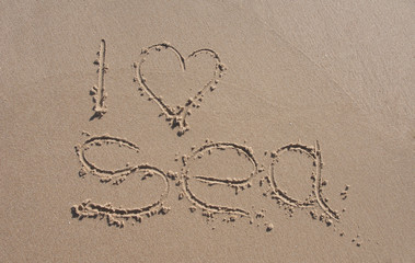 inscription on the beach sand i love sea