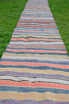 Handmade striped mat on the grass